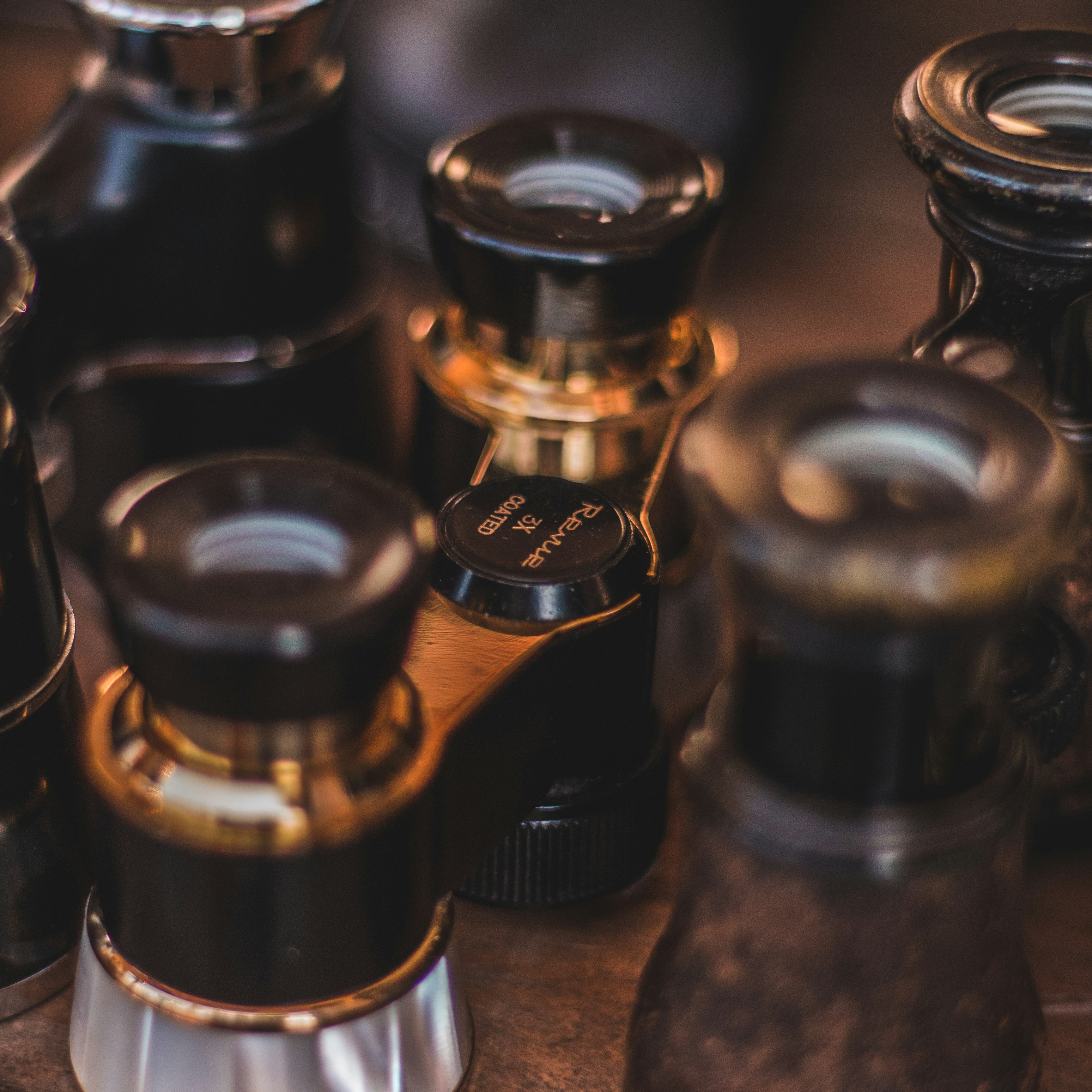 black glass bottles on brown wooden table